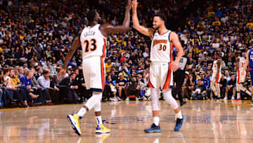 OAKLAND, CA - APRIL 7: Draymond Green #23 of the Golden State Warriors high-fives Stephen Curry #30 of the Golden State Warriors against the LA Clippers on April 7, 2019 at ORACLE Arena in Oakland, California. NOTE TO USER: User expressly acknowledges and agrees that, by downloading and or using this photograph, user is consenting to the terms and conditions of Getty Images License Agreement. Mandatory Copyright Notice: Copyright 2019 NBAE (Photo by Noah Graham/NBAE via Getty Images)