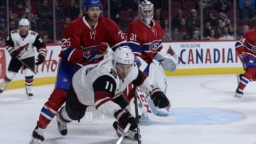 Oct 20, 2016; Montreal, Quebec, CAN; Arizona Coyotes forward Martin Hanzal (11) dives for the puck while Montreal Canadiens defenseman Jeff Petry (26) defends during the first period at the Bell Centre. Mandatory Credit: Eric Bolte-USA TODAY Sports