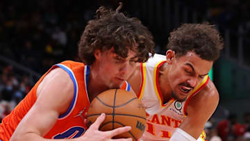Trae Young #11 of the Atlanta Hawks defends against Josh Giddey #3 of the Oklahoma City Thunder during the first half at State Farm Arena on November 22, 2021 in Atlanta, Georgia. NOTE TO USER: User expressly acknowledges and agrees that, by downloading and or using this photograph, User is consenting to the terms and conditions of the Getty Images License Agreement. (Photo by Kevin C. Cox/Getty Images)