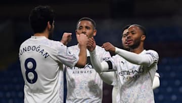 Manchester City's English midfielder Raheem Sterling (R) celebrates scoring his team's second goal with Manchester City's Brazilian striker Gabriel Jesus (C) during the English Premier League football match between Burnley and Manchester City at Turf Moor in Burnley, north west England on February 3, 2021. (Photo by Gareth Copley / POOL / AFP) / RESTRICTED TO EDITORIAL USE. No use with unauthorized audio, video, data, fixture lists, club/league logos or 'live' services. Online in-match use limited to 120 images. An additional 40 images may be used in extra time. No video emulation. Social media in-match use limited to 120 images. An additional 40 images may be used in extra time. No use in betting publications, games or single club/league/player publications. / (Photo by GARETH COPLEY/POOL/AFP via Getty Images)