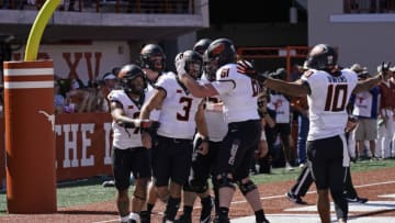 Oct 16, 2021; Austin, Texas, USA; Oklahoma State Cowboys quarterback Spencer Sanders (3) celebrates with teammates after running for a touchdown in second half against the Texas Longhorns at Darrell K Royal-Texas Memorial Stadium. Mandatory Credit: Scott Wachter-USA TODAY Sports