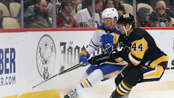 Oct 7, 2022; Pittsburgh, Pennsylvania, USA; Buffalo Sabres center Casey Mittelstadt (37) and Pittsburgh Penguins defenseman Jan Rutta (44) chase the puck during the third period at PPG Paints Arena. The Penguins won 7-1. Mandatory Credit: Charles LeClaire-USA TODAY Sports