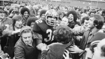 Pittsburgh Steelers' running back Franco Harris is mobed by fans at Three Rivers Stadium after scoring the winning touchdown, nicknamed the 'Immaculate Reception,' during the American Football Conference (AFC) semi-final game against Oakland. Harris made the touchdown, one of the most famous single plays in the history of professional American football, on a tipped pass from quarterback Terry Bradshaw to Frenchy Fuqua to Harris for the score in the fourth quarter in Pittsburgh.