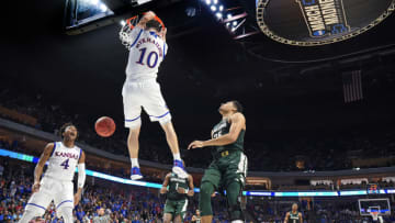 Kansas' Svi Mykhailiuk (10) throws down an alley-oop dunk served up by teammate Devonte' Graham (4) against Michigan State during the first half on Sunday, March 19, 2017 in the second round of the NCAA men's basketball tournament at the BOK Center in Tulsa, Okla. (Rich Sugg/Kansas City Star/TNS via Getty Images)