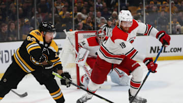 BOSTON - MAY 12: Boston Bruins' Brad Marchand (63) chases a loose puck in the first period with Carolina's Dougie Hamilton (19). The Boston Bruins host the Carolina Hurricanes in Game 2 of the NHL Eastern Conference Finals on May 12, 2019. (Photo by John Tlumacki/The Boston Globe via Getty Images)