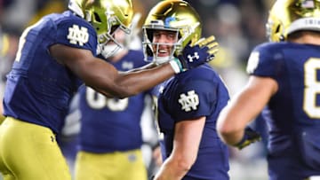 Oct 30, 2021; South Bend, Indiana, USA; Notre Dame Fighting Irish quarterback Jack Coan (17) celebrates with wide receiver Kevin Austin Jr. (4) after a touchdown in the second quarter against the North Carolina Tar Heels at Notre Dame Stadium. Mandatory Credit: Matt Cashore-USA TODAY Sports