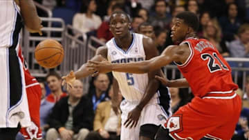Jan 15, 2014; Orlando, FL, USA; Orlando Magic shooting guard Victor Oladipo (5) passes the ball around Chicago Bulls shooting guard Jimmy Butler (21) during the second quarter at Amway Center. Mandatory Credit: Kim Klement-USA TODAY Sports