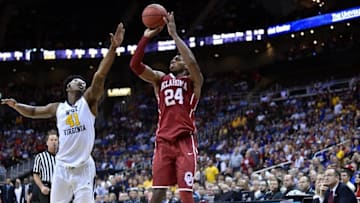 Mar 11, 2016; Kansas City, MO, USA; Oklahoma Sooners guard Buddy Hield (24) shoots a jump shot as West Virginia Mountaineers forward Devin Williams (41) defends in the second half during the Big 12 Conference tournament at Sprint Center. West Virginia won 69-67. Mandatory Credit: Denny Medley-USA TODAY Sports