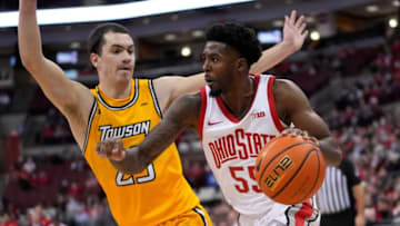 Ohio State Buckeyes guard Jamari Wheeler (55) dribbles around Towson Tigers guard Nicolas Timberlake (25) during the first half of the NCAA men's basketball game at Value City Arena in Columbus on Wednesday, Dec. 8, 2021.Towson Tigers At Ohio State Buckeyes Basketball