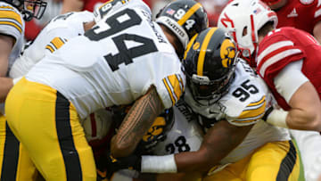 LINCOLN, NE - NOVEMBER 29: Defensive end A.J. Epenesa #94 of the Iowa Hawkeyes and defensive lineman Cedrick Lattimore #95 combine to stop a Nebraska Cornhuskers runner at Memorial Stadium on November 29, 2019 in Lincoln, Nebraska. (Photo by Steven Branscombe/Getty Images)