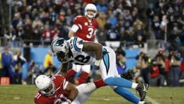 Jan 24, 2016; Charlotte, NC, USA; Arizona Cardinals running back David Johnson (31) is brought down by Carolina Panthers outside linebacker Thomas Davis (58) as Arizona Cardinals quarterback Carson Palmer (3) looks on during the second quarter in the NFC Championship football game at Bank of America Stadium. Mandatory Credit: Jason Getz-USA TODAY Sports