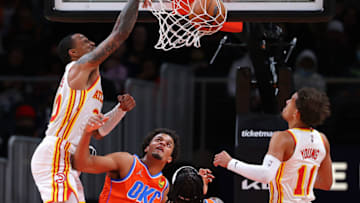 ATLANTA, GEORGIA - NOVEMBER 22: John Collins #20 of the Atlanta Hawks dunks against Jeremiah Robinson-Earl #50 of the Oklahoma City Thunder during the first half at State Farm Arena on November 22, 2021 in Atlanta, Georgia. NOTE TO USER: User expressly acknowledges and agrees that, by downloading and or using this photograph, User is consenting to the terms and conditions of the Getty Images License Agreement. (Photo by Kevin C. Cox/Getty Images)