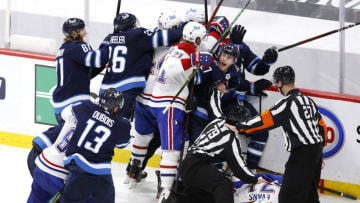 Jun 2, 2021; Winnipeg, Manitoba, CAN; Winnipeg Jets left wing Nikolaj Ehlers (27) attempts to keep players away from injured Montreal Canadiens center Jake Evans (71) after a hit by Jets center Mark Scheifele (not pictured) in game one of the second round of the 2021 Stanley Cup Playoffs at Bell MTS Place. Mandatory Credit: James Carey Lauder-USA TODAY Sports
