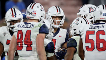 PASADENA, CALIFORNIA - NOVEMBER 12: Tetairoa McMillan #4 of the Arizona Wildcats reacts with teammates after his touchdown catch, to take a 31-24 lead over the UCLA Bruins during a 31-28 Wildcats win at Rose Bowl on November 12, 2022 in Pasadena, California. (Photo by Harry How/Getty Images)