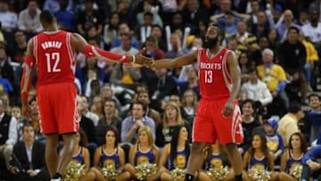 Feb 20, 2014; Oakland, CA, USA; Houston Rockets shooting guard James Harden (13) celebrates with center Dwight Howard (12) after a play against the Golden State Warriors during the fourth quarter at Oracle Arena. The Golden State Warriors defeated the Houston Rockets 102-99 in overtime. Mandatory Credit: Kelley L Cox-USA TODAY Sports