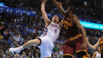Dec 11, 2014; Oklahoma City, OK, USA; Oklahoma City Thunder forward Nick Collison (4) attempts a shot against Cleveland Cavaliers forward Tristan Thompson (13) during the fourth quarter at Chesapeake Energy Arena. Mandatory Credit: Mark D. Smith-USA TODAY Sports