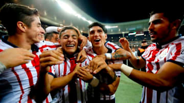 Alexis Vega is mobbed by teammates after scoring against Atlas during the Clausura 2019 Clasico Tapatio. (Photo by Ulises Ruiz / AFP) (Photo credit should read ULISES RUIZ/AFP/Getty Images)