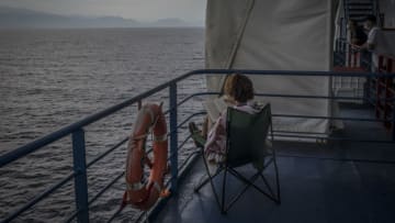 AT SEA, GREECE - AUGUST 8: A woman reads a book on the dock of a passenger ship sailing from Italy to Greece on August 8, 2020 at sea between Italy and Greece. Passenger ships resume sailings more than three months after they were suspended due to coronavirus travel restrictions. (Photo by Siegfried Modola/Getty Images)