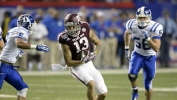 Dec 31, 2013; Atlanta, GA, USA; Texas A&M Aggies wide receiver Mike Evans (13) catches a pass between Duke Blue Devils cornerback Ross Cockrell (6) and Kyler Brown (56) during the second quarter in the 2013 Chick-fil-a Bowl at the Georgia Dome. Mandatory Credit: John David Mercer-USA TODAY Sports