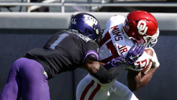 Oct 24, 2020; Fort Worth, Texas, USA; Oklahoma Sooners wide receiver Marvin Mims (17) scores a touchdown as TCU Horned Frogs cornerback Tre'Vius Hodges-Tomlinson (1) defends during the first half at Amon G. Carter Stadium. Mandatory Credit: Kevin Jairaj-USA TODAY Sports