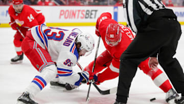 Feb 23, 2023; Detroit, Michigan, USA; Detroit Red Wings center Joe Veleno (90) faces off against New York Rangers center Mika Zibanejad (93) during the second period at Little Caesars Arena. Mandatory Credit: Brian Bradshaw Sevald-USA TODAY Sports