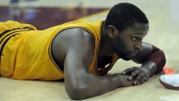 Jan 5, 2014; Cleveland, OH, USA; Cleveland Cavaliers shooting guard C.J. Miles (0) lays on the court in the fourth quarter against the Indiana Pacers at Quicken Loans Arena. Mandatory Credit: David Richard-USA TODAY Sports