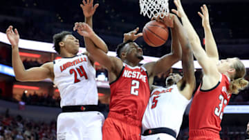 LOUISVILLE, KENTUCKY - JANUARY 24: Dwayne Sutton #24 and Malik Williams #5 of the Louisville Cardinals battle with Torin Dorn #2 and Wyatt Walker #33 of the North Carolina State Wolfpack for a rebound at KFC YUM! Center on January 24, 2019 in Louisville, Kentucky. (Photo by Andy Lyons/Getty Images)