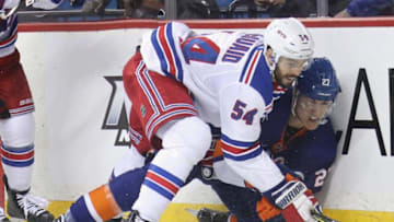 Adam McQuaid #54 of the New York Rangers checks Anders Lee #27 of the New York Islanders into the boards during the second period at the Barclays Center. (Photo by Bruce Bennett/Getty Images)