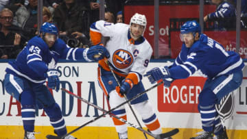 TORONTO, ON - FEBRUARY 22: John Tavares #91 of the New York Islanders battles with Patrick Marleau #12 and Nazem Kadri #43 of the Toronto Maple Leafs during the third period at the Air Canada Centre on February 22, 2018 in Toronto, Ontario, Canada. (Photo by Mark Blinch/NHLI via Getty Images)