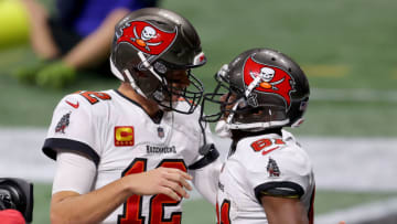 ATLANTA, GEORGIA - DECEMBER 20: Antonio Brown #81 of the Tampa Bay Buccaneers celebrates with Tom Brady #12 after scoring a 46 touchdown against the Atlanta Falcons during the fourth quarter in the game at Mercedes-Benz Stadium on December 20, 2020 in Atlanta, Georgia. (Photo by Kevin C. Cox/Getty Images)
