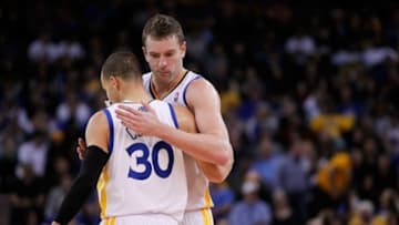 Jan 26, 2014; Oakland, CA, USA; Golden State Warriors guard Stephen Curry (30) is met by forward David Lee (10) after the Warriors scored a basket against the Portland Trail Blazers in the fourth quarter at Oracle Arena. The Warriors defeated the Trail Blazers 103-88. Mandatory Credit: Cary Edmondson-USA TODAY Sports