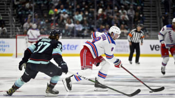 Oct 31, 2021; Seattle, Washington, USA; New York Rangers defenseman Jacob Trouba (8) moves the puck while being defended by Seattle Kraken center Yanni Gourde (37) during the second period at Climate Pledge Arena. New York defeated Seattle 3-1. Mandatory Credit: Steven Bisig-USA TODAY Sports