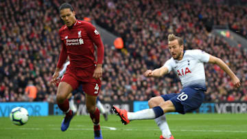 LIVERPOOL, ENGLAND - MARCH 31: Harry Kane of Tottenham Hotspur shoots under pressure from Virgil Van Dijk of Liverpool during the Premier League match between Liverpool FC and Tottenham Hotspur at Anfield on March 31, 2019 in Liverpool, United Kingdom. (Photo by Shaun Botterill/Getty Images)