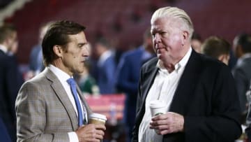 VANCOUVER, BRITISH COLUMBIA - JUNE 22: President George McPhee (L) of the Vegas Golden Knights and executive Brian Burke talk on the draft floor during Rounds 2-7 of the 2019 NHL Draft at Rogers Arena on June 22, 2019 in Vancouver, Canada. (Photo by Jeff Vinnick/NHLI via Getty Images)
