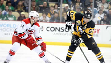 Mar 17, 2016; Pittsburgh, PA, USA; Pittsburgh Penguins center Sidney Crosby (87) moves the puck as Carolina Hurricanes left wing Phil Di Giuseppe (34) pressures during the second period at the CONSOL Energy Center. Mandatory Credit: Charles LeClaire-USA TODAY Sports