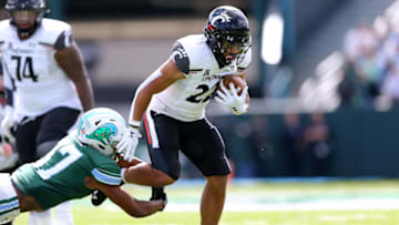 Ryan Montgomery of the Cincinnati Bearcats runs with the ball against the Tulane Green Wave. Getty Images.