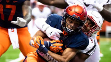SYRACUSE, NY - NOVEMBER 09: Sean Riley #10 of the Syracuse Orange is brought down by C.J. Avery #9 of the Louisville Cardinals during the first quarter at the Carrier Dome on November 9, 2018 in Syracuse, New York. (Photo by Brett Carlsen/Getty Images)
