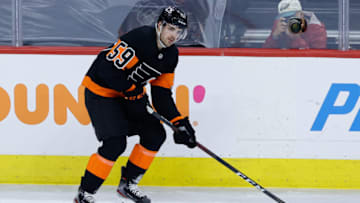 PHILADELPHIA, PENNSYLVANIA - APRIL 25: Jackson Cates #59 of the Philadelphia Flyers passes during a game against the New Jersey Devils at Wells Fargo Center on April 25, 2021 in Philadelphia, Pennsylvania. (Photo by Tim Nwachukwu/Getty Images)