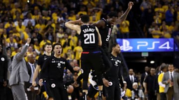 OAKLAND, CALIFORNIA - APRIL 15: Landry Shamet #20 of the LA Clippers is congratulated by Patrick Beverley #21 after he made a basket to put the Clippers ahead of the Golden State Warriors in the final minute during Game Two of the first round of the 2019 NBA Western Conference Playoffs at ORACLE Arena on April 15, 2019 in Oakland, California. NOTE TO USER: User expressly acknowledges and agrees that, by downloading and or using this photograph, User is consenting to the terms and conditions of the Getty Images License Agreement. (Photo by Ezra Shaw/Getty Images)