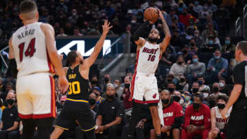 Miami Heat forward Caleb Martin (16) makes a three point basket over Golden State Warriors guard Stephen Curry(Cary Edmondson-USA TODAY Sports)