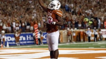 Sep 21, 2013; Austin, TX, USA; Texas Longhorns running back Johnathan Gray (32) celebrates his touchdown giving the Longhorn salute to the crowd against the Kansas State Wildcats during the third quarter of a football game at Darrell K Royal-Texas Memorial Stadium. Mandatory Credit: Jim Cowsert-USA TODAY Sports