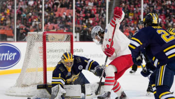 Feb 18, 2023; Cleveland, Ohio, USA; Ohio State Buckeyes forward Cam Thiesing (15) tries to shovel the puck past Michigan Wolverines goaltender Erik Portillo (1) during the first period of the Faceoff on the Lake outdoor NCAA men’s hockey game at FirstEnergy Stadium. Mandatory Credit: Adam Cairns-The Columbus DispatchHockey Ncaa Men S Hockey Michigan Wolverines At Ohio State Buckeyes