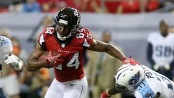 Aug 23, 2014; Atlanta, GA, USA; Atlanta Falcons wide receiver Roddy White (84) makes a move on Tennessee Titans strong safety Bernard Pollard (31) after a catch in the first quarter of their game at the Georgia Dome. The Titans won 24-17. Mandatory Credit: Jason Getz-USA TODAY Sports