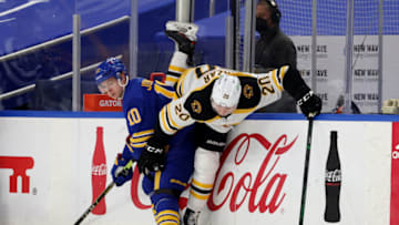 Apr 20, 2021; Buffalo, New York, USA; Buffalo Sabres defenseman Henri Jokiharju (10) checks Boston Bruins center Curtis Lazar (20) as he skates with the puck during the third period at KeyBank Center. Mandatory Credit: Timothy T. Ludwig-USA TODAY Sports