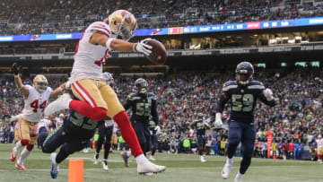 SEATTLE, WA - DECEMBER 02: Dante Pettis #18 of the San Francisco 49ers catches the ball over Tedric Thompson #33 of the Seattle Seahawks for a touchdown in the third quarter at CenturyLink Field on December 2, 2018 in Seattle, Washington. (Photo by Abbie Parr/Getty Images)