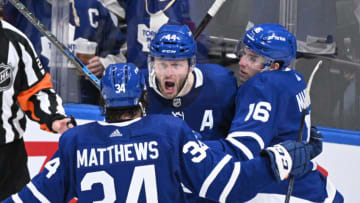 May 14, 2022; Toronto, Ontario, CAN; Toronto Maple Leafs defenseman Morgan Rielly (44) celebrates with forward Mitch Marner (16) and forward Auston Matthews (34) after scoring a goal against the Tampa Bay Lightning in the second period of game seven of the first round of the 2022 Stanley Cup Playoffs at Scotiabank Arena. Mandatory Credit: Dan Hamilton-USA TODAY Sports