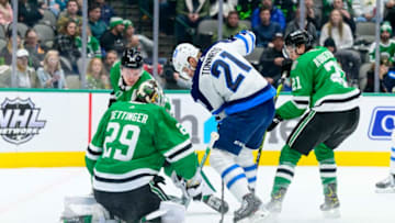 Feb 23, 2022; Dallas, Texas, USA; Dallas Stars goaltender Jake Oettinger (29) stops a shot by Winnipeg Jets center Dominic Toninato (21) during the first period at the American Airlines Center. Mandatory Credit: Jerome Miron-USA TODAY Sports