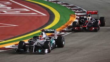 SINGAPORE - SEPTEMBER 25: Michael Schumacher of Germany and Mercedes GP leads from Lewis Hamilton of Great Britain and McLaren before crashing out during the Singapore Formula One Grand Prix at the Marina Bay Street Circuit on September 25, 2011 in Singapore. (Photo by Mark Thompson/Getty Images)