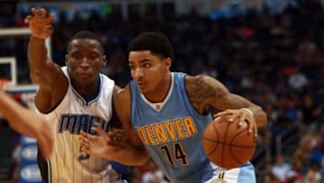 Mar 15, 2016; Orlando, FL, USA; Denver Nuggets guard Gary Harris (14) drives to the basket as Orlando Magic guard Victor Oladipo (5) defends during the second quarter at Amway Center. Mandatory Credit: Kim Klement-USA TODAY Sports