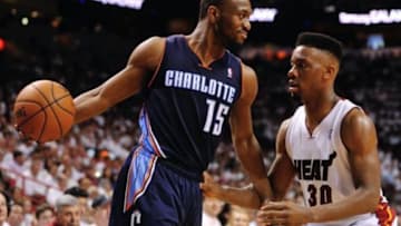 Apr 23, 2014; Miami, FL, USA; Charlotte Bobcats guard Kemba Walker (15) is pressured by Miami Heat guard Norris Cole (30) in game two during the first round of the 2014 NBA Playoffs at American Airlines Arena. Mandatory Credit: Steve Mitchell-USA TODAY Sports